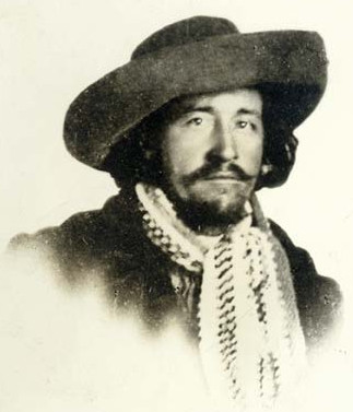 [Image: David C. McCanles in a rather outlandishly large hat, with a decorative scarf]