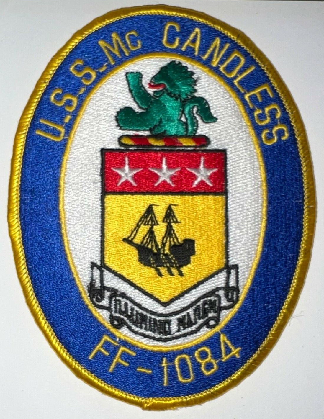 [Image: Oval military patch reading 'U.S.S. McCandless FF-1084', and featuring the McCandlish/McCandless coat of arms, with lion crest, and the motto 'Illumino Marem']