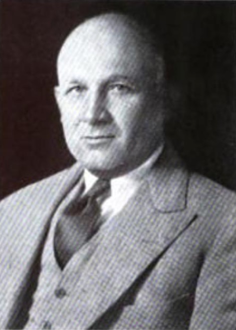 [Image: Alva McAndless at about age 45, a balding man in a light suit and dark necktie]